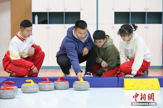1月6日，一位体育老师在给学生讲解“陆地冰壶”项目。 瞿宏伦 摄