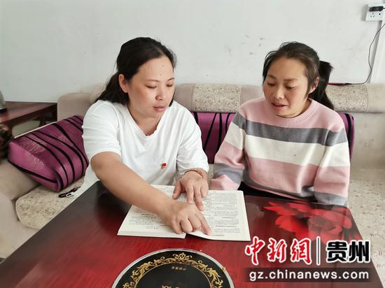 蔡艳（左）辅导妇女群众学政策法规。丽景社区 供图