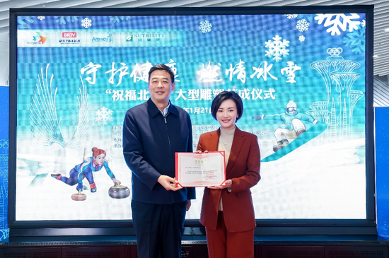 北京奥运城市发展促进中心主任付晓辉（左一）向安利（中国）市场副总裁童晶菁（右一）颁发特殊贡献荣誉证书