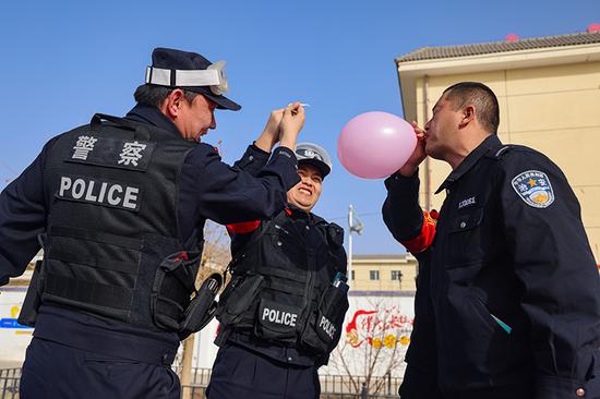 民警开展合力吹气球游戏。