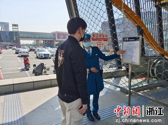 杭海城铁皮革城站员工向乘客解释停运原因并引导乘客选择其他出行工具。 刘宁 摄
