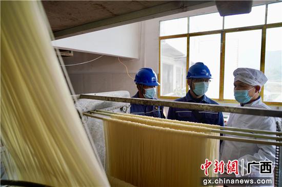 南方电网广西柳州柳城供电局工作人员到丹军米粉场检查米粉生产用电情况。马聪 摄