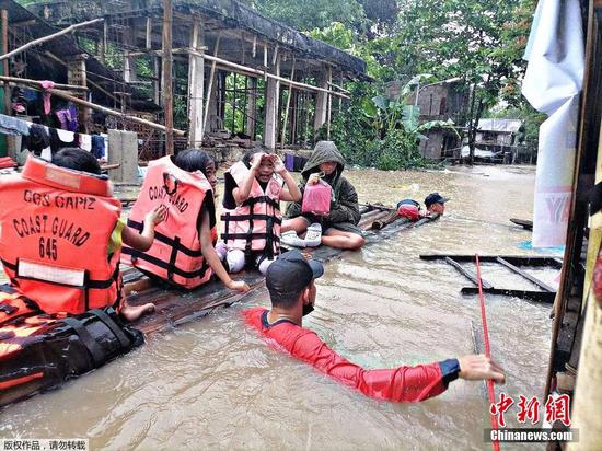 当地时间4月11日，菲律宾救灾部门说，热带风暴“鲇鱼”在菲律宾登陆后引发洪水和山体滑坡，已造成至少24人死亡，超过13万人受灾。图为图为菲律宾海岸警卫队在卡皮兹省帕尼坦镇疏散居民。
