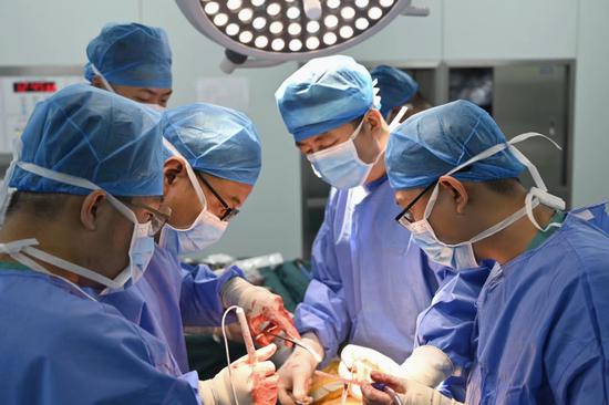 吴昊天副院长（右二）与援疆专家黄晓丹博士（左二）为患者做髋关节置换手术。