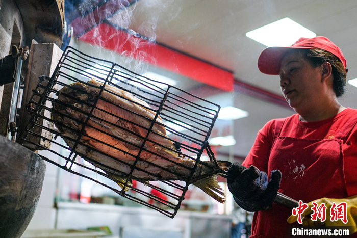 　　圖為5月19日，重慶萬州，一家烤魚店內工作人員正在烤制烤魚。?中新社記者 何蓬磊 攝

