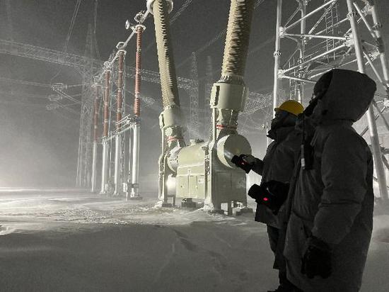 11月26日，国网新疆超高压分公司员工在750千伏喀纳斯变电站进行极寒天气设备特巡工作。董辉 摄