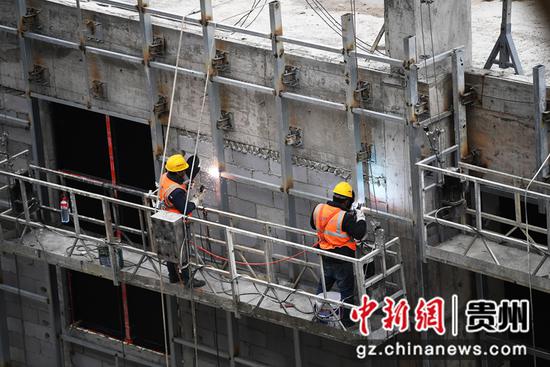 12月12日，在贵阳市南明区南明智能制造产业园三期项目建设现场，中铁八局集团第三工程有限公司的工人正在焊接幕墙龙骨。