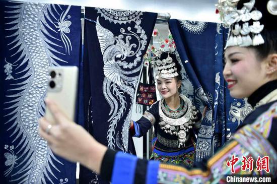 在贵州省榕江县兴华乡摆贝苗寨，妇女在鼓藏节活动上拍摄留念。　王炳真 摄