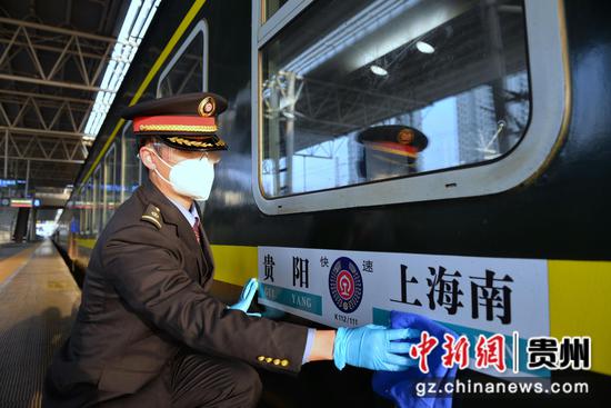 贵阳至上海南的K112次列车在贵阳站始发前，薛太鑫擦抹区间牌。黄春海  摄