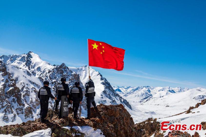 Police officers patrol in snow in Xinjiang