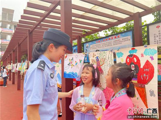 图为同学们邀请友谊关边检站移民管理警察欣赏绘画作品。罗晓  摄