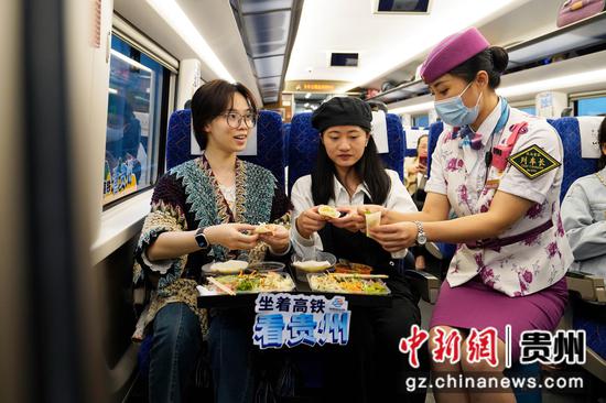 黄立静为列车上的游客们推介贵州特色小吃丝娃娃。 沈向全 摄