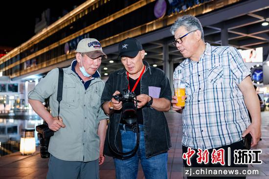 　　 中国新闻社编委毛建军（右）、中国摄影金像奖获得者郭建设（中）张兆增（左）在创作交流。 主办方供图
