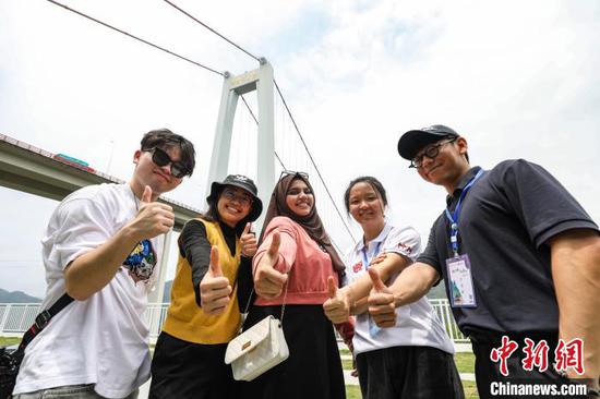 6月3日，五位留学生点赞坝陵河大桥。　中新社记者 瞿宏伦 摄