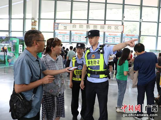 图为移民管理警察在景区为游客提供服务