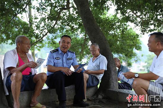 图为民警向村民讲解反诈知识。甘勇 摄 图为民警向村民讲解反诈知识。甘勇 摄