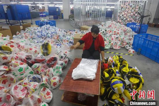 图为工人在贵州一体育用品有限公司生产车间赶制外贸出口订单。磨桂宾 摄