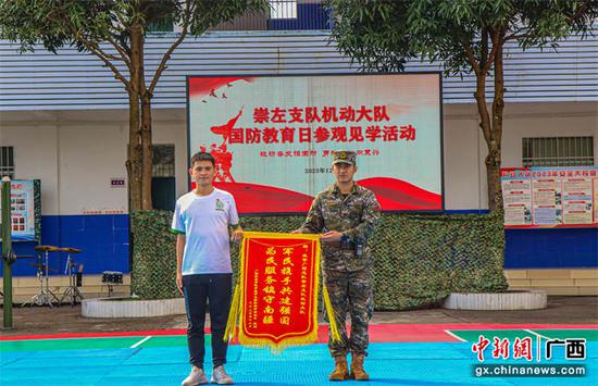 图为师生为官兵赠送锦旗。 吴志恒 摄 图为师生为官兵赠送锦旗。 吴志恒 摄