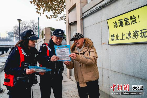 民警向市民发放防溺水宣传单，并讲解冰面安全等相关知识。 天津市公安局供图