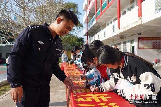 学生在反诈横幅上签下了自己的名字。 王昌昱  摄