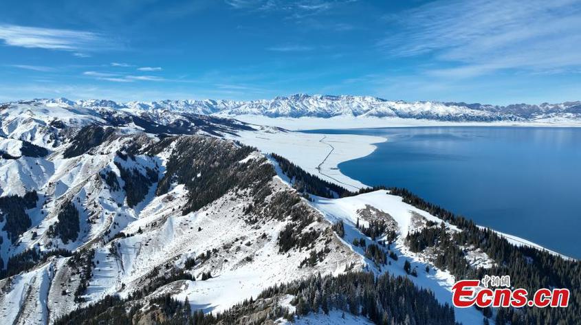 Surrounded by the snow-capped Tianshan Mountains, Sayram Lake, the largest alpine lake, shines under the blue sky in Bortala Mongolian Autonomous Prefecture, northwest China's Xinjiang Uyghur Autonomous Region. (Photo provided to China News Service)