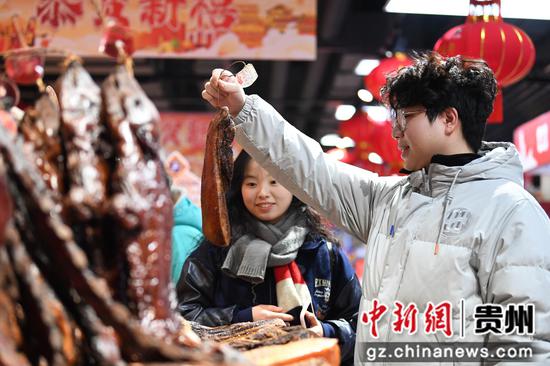 1月26日，市民在贵阳市南明区合力超市花果园R区店内选购腊肉。