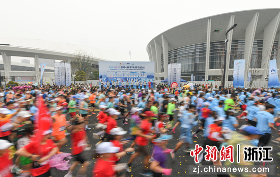 众多跑者从亚运场馆前跑过。中新社记者 王刚 摄