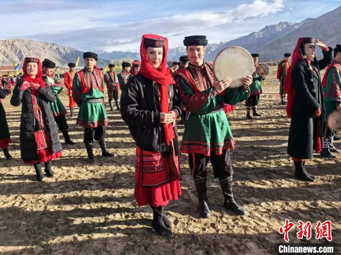 3月21日，新疆塔县举行非物质文化遗产及传统体育展示展演活动。图为当地塔吉克族男女身着民族服饰，静待展演活动开始。马晓东 摄