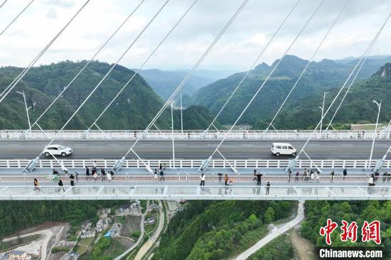 图为游客在龙里河大桥上观光、游览。中新网记者 瞿宏伦 摄