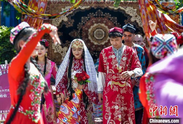“新郎新娘”在亲友的簇拥下来到婚礼现场。中新网记者 刘新 摄