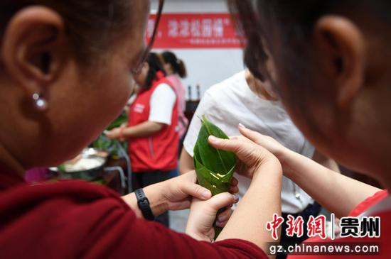 6月6日，贵阳市南明区五里冲街道松园居委会的志愿者与辖区居民一起包粽子。