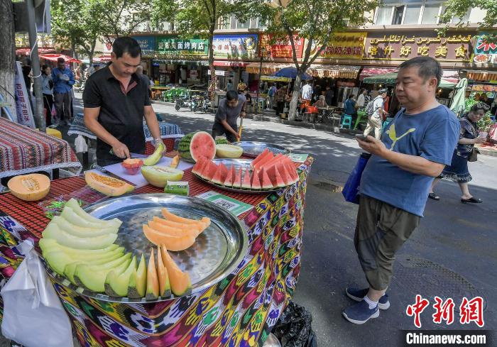 
8月2日，新疆烏魯木齊市沙依巴克區(qū)和田二街，游客在街頭品嘗手工冰淇淋。據(jù)介紹，和田二街匯集了抓飯、烤包子、烤肉等新疆各地特色美食，穿行在街道間，香氣四溢，令人垂涎。由于親民的價(jià)格，和田二街火遍各大網(wǎng)絡(luò)平臺(tái)，成為名副其實(shí)的“網(wǎng)紅街”，吸引眾多游客慕名而來(lái)。中新社記者 劉新 攝

8月2日，新疆烏魯木齊市沙依巴克區(qū)和田二街，一家飯店的廚師正忙碌著，門前的各種美食吸引游客排隊(duì)購(gòu)買。據(jù)介紹，和田二街匯集了抓飯、烤包子、烤肉等新疆各地特色美食，穿行在街道間，香氣四溢，令人垂涎。由于親民的價(jià)格，和田二街火遍各大網(wǎng)絡(luò)平臺(tái)，成為名副其實(shí)的“網(wǎng)紅街”，吸引眾多游客慕名而來(lái)。中新社記者 劉新 攝

8月2日，新疆烏魯木齊市沙依巴克區(qū)和田二街，游客選購(gòu)羊腿抓飯。據(jù)介紹，和田二街匯集了抓飯、烤包子、烤肉等新疆各地特色美食，穿行在街道間，香氣四溢，令人垂涎。由于親民的價(jià)格，和田二街火遍各大網(wǎng)絡(luò)平臺(tái)，成為名副其實(shí)的“網(wǎng)紅街”，吸引眾多游客慕名而來(lái)。中新社記者 劉新 攝

8月2日，新疆烏魯木齊市沙依巴克區(qū)和田二街，新鮮出爐的烤馕吸引游客。據(jù)介紹，和田二街匯集了抓飯、烤包子、烤肉等新疆各地特色美食，穿行在街道間，香氣四溢，令人垂涎。由于親民的價(jià)格，和田二街火遍各大網(wǎng)絡(luò)平臺(tái)，成為名副其實(shí)的“網(wǎng)紅街”，吸引眾多游客慕名而來(lái)。中新社記者 劉新 攝

8月2日，新疆烏魯木齊市沙依巴克區(qū)和田二街，游客漫步在街道上。據(jù)介紹，和田二街匯集了抓飯、烤包子、烤肉等新疆各地特色美食，穿行在街道間，香氣四溢，令人垂涎。由于親民的價(jià)格，和田二街火遍各大網(wǎng)絡(luò)平臺(tái)，成為名副其實(shí)的“網(wǎng)紅街”，吸引眾多游客慕名而來(lái)。中新社記者 劉新 攝

8月2日，新疆烏魯木齊市沙依巴克區(qū)和田二街，飯店門前擺放的特色美食吸引游客。據(jù)介紹，和田二街匯集了抓飯、烤包子、烤肉等新疆各地特色美食，穿行在街道間，香氣四溢，令人垂涎。由于親民的價(jià)格，和田二街火遍各大網(wǎng)絡(luò)平臺(tái)，成為名副其實(shí)的“網(wǎng)紅街”，吸引眾多游客慕名而來(lái)。中新社記者 劉新 攝

8月2日，新疆烏魯木齊市沙依巴克區(qū)和田二街，游客在街頭品嘗剛剛出爐的熱馕。據(jù)介紹，和田二街匯集了抓飯、烤包子、烤肉等新疆各地特色美食，穿行在街道間，香氣四溢，令人垂涎。由于親民的價(jià)格，和田二街火遍各大網(wǎng)絡(luò)平臺(tái)，成為名副其實(shí)的“網(wǎng)紅街”，吸引眾多游客慕名而來(lái)。中新社記者 劉新 攝 