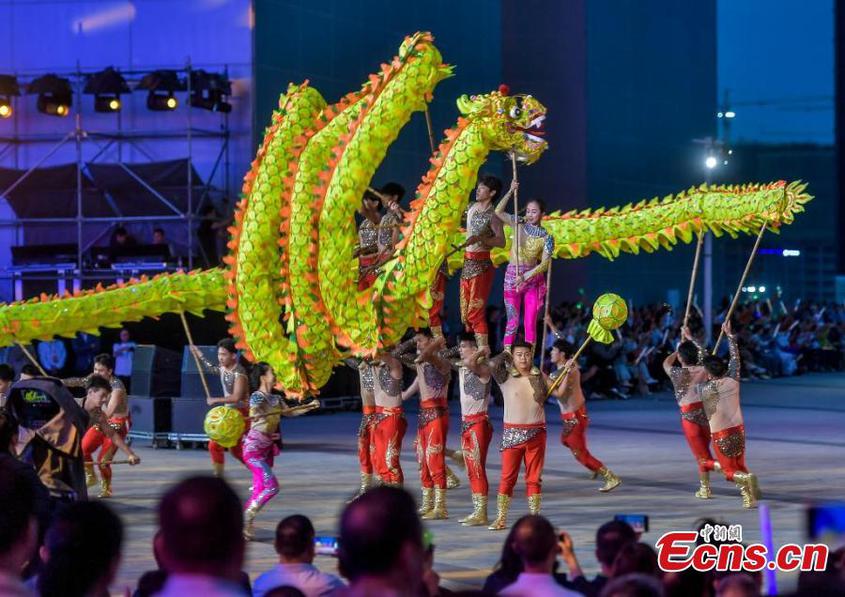 Artists from Tacheng Prefecture, northwest China's Xinjiang Uyghur Autonomous Region, perform a dance during the first folk art season in Urumqi, capital of Xinjiang, Aug. 20, 2024. (Photo: China News Service/Liu Xin)