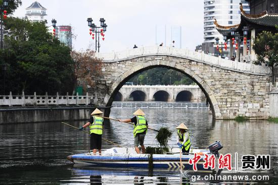 9月12日，贵阳市河湖保护中心的河道疏捞工人正在甲秀楼河段清理水草及水体漂浮物。