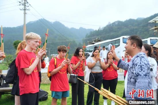 图为美国青少年在贵州台江学习吹芦笙。周燕玲 摄 图为美国青少年在贵州台江学习吹芦笙。周燕玲 摄