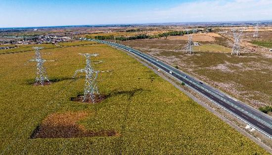 2024年9月28日，塔城—烏蘇750千伏輸電線路工程跨越連霍高速。（馬元 攝）