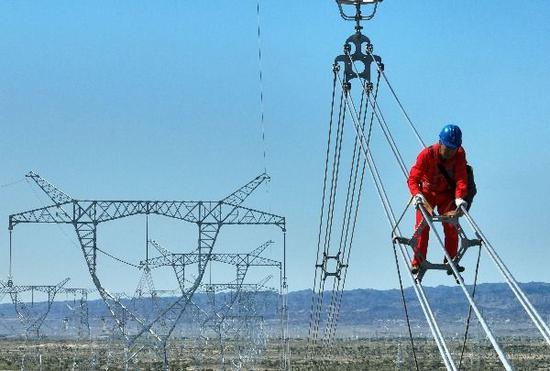 2024年8月15日，電力員工對塔城—烏蘇750千伏輸變電工程開展走線消缺。（馬元 攝）