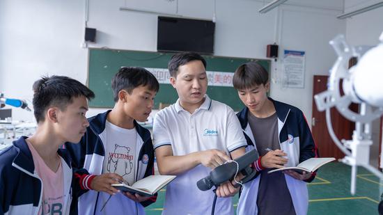 刘永贵和学生探讨交流工业机器人技术