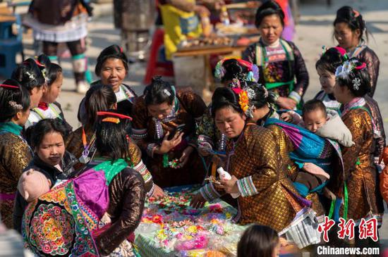 图为苗族妇女在大塘苗寨选购饰品。吴德军 摄 图为苗族妇女在大塘苗寨选购饰品。吴德军 摄