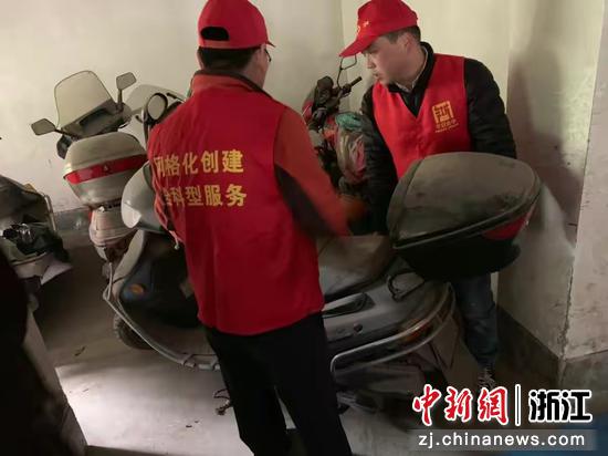 “香溢”志愿者正把布满灰尘的电动车移到集中停车点位里。金华烟草 供图