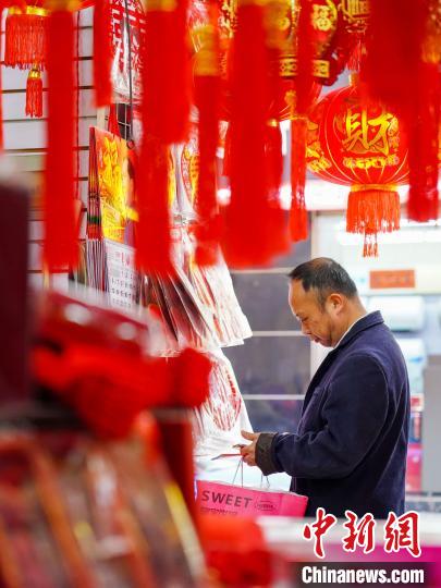 1月7日，市民在贵州省从江县一年货集市选购新春饰品。卢忠南 摄
