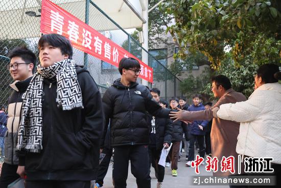 图为：考生自信走入绍兴市上虞区崧厦中学考点。中新社发 于江 摄