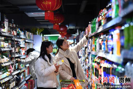 1月14日，市民正在贵阳市南明区惠民生鲜合力超市南浦路店年货大街选购选购商品。