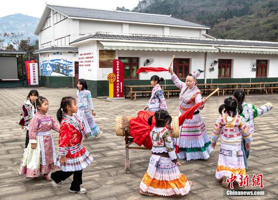 图为“童伴妈妈”杨国美和孩子们跳苗家打鼓舞。 图为“童伴妈妈”杨国美和孩子们跳苗家打鼓舞。