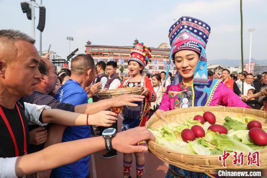 图为墨江自治县民众在“村超”球场向观众分享美食。中新网记者瞿宏伦 摄 图为墨江自治县民众在“村超”球场向观众分享美食。中新网记者瞿宏伦 摄