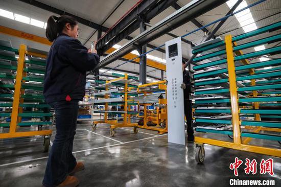 图为工人在检查电梯部件。中新社记者 瞿宏伦 摄 图为工人在检查电梯部件。中新社记者 瞿宏伦 摄
