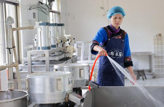 ↑ 4月25日，陈星星在作坊内清洗制作灰豆腐的器具。