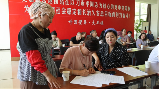 5月21日,餐饮、食品零售商户正在签订《食品安全承诺书》(朱含雪 摄)
