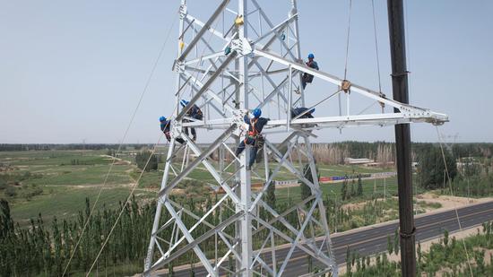 阿克苏中电建沙雅升压汇集站220千伏送出工程杆塔组立现场。马海骄 摄 阿克苏中电建沙雅升压汇集站220千伏送出工程杆塔组立现场。马海骄 摄
