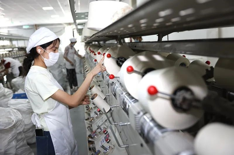 6月17日,喀什经济开发区某织布企业整经车间工人进行纺纱卷绕。喀什地区融媒体中心 记者陈文军 摄 6月17日,喀什经济开发区某织布企业整经车间工人进行纺纱卷绕。喀什地区融媒体中心 记者陈文军 摄